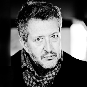 Close-up portrait of Thomas Adès looking directly into the camera.